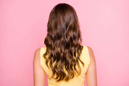 Back rear spine view photo of young lady with beautiful perfect long wavy silky glossy hair isolated on pink color backgroundの写真素材