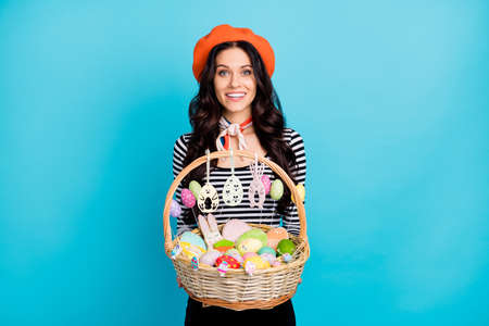 Photo of young girl happy positive smile hold big wicker easter basket confectionery cookies...