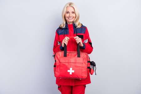 Portrait of positive person hands hold bag have good mood look camera isolated on grey color backgroundの写真素材