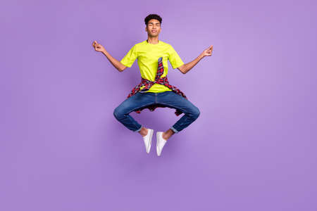 Full length body size photo of young hipster jumping up doing yoga asana calm peaceful isolated on...