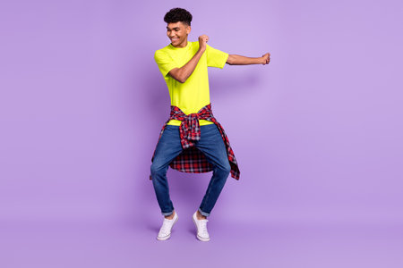 Full size photo of young handsome funky happy cheerful smiling afro man dancing isolated on purple...