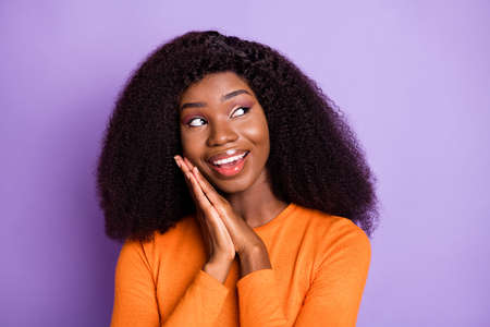 Portrait of charming cheerful wavy-haired girl enjoying looking aside good news isolated over violet...