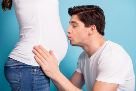 Cropper profile photo of spouse guy closed eyes touch kiss stomach white t-shirt isolated on blue...