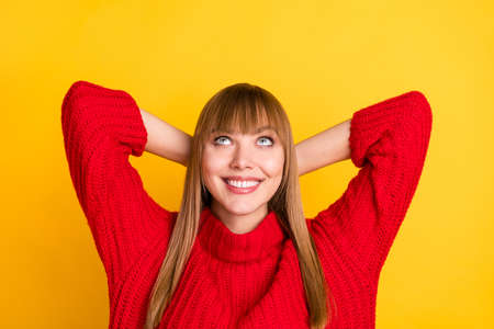Photo of blond optimistic lady hands head sleep look empty space wear red sweater isolated on bright yellow color backgroundの写真素材