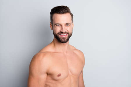 Close-up portrait of attractive content cheerful perfect naked brunet guy posing isolated over light grey color backgroundの写真素材