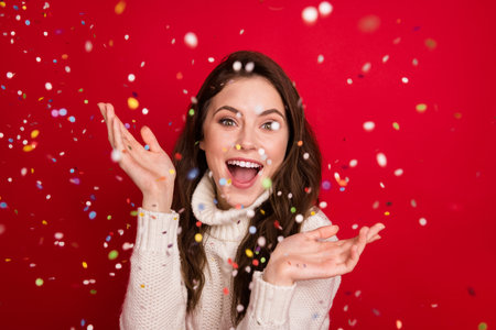 Photo of dreamy funny young lady wear collar pullover throwing arms glitter smiling isolated red color backgroundの写真素材