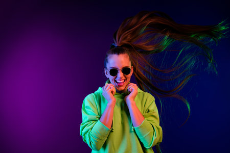 Photo of funny charming young woman dressed green pullover dancing arms earphones isolated vivid...