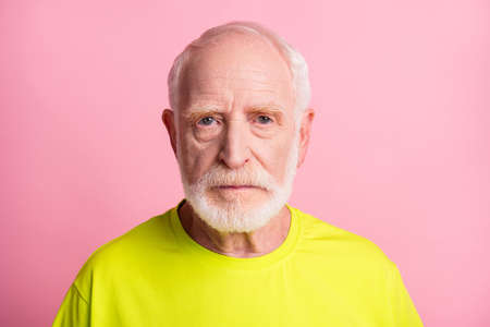 Close up portrait of old person no emotions look camera lime clothing isolated on pastel pink color...