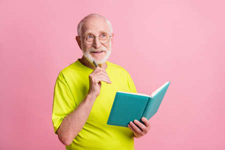 Portrait of funky pensioner write notebook look empty space wear spectacles green color t-shirt...