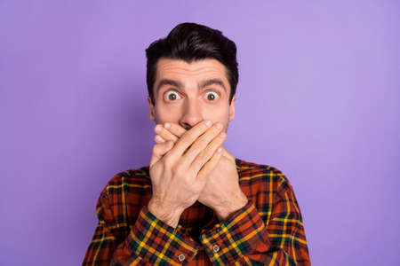 Photo of crazy guy crossed palms cover mouth look camera wear bow tie plaid shirt isolated purple...