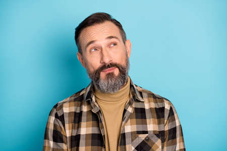 Photo portrait of aged man curious dreamy got idea looking copyspace isolated on vibrant blue color...