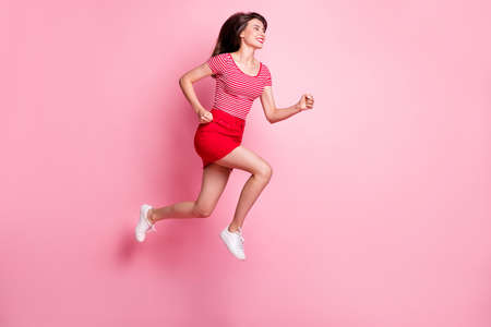 Full size profile side photo of young attractive smiling positive girl jump run fast look copyspace...