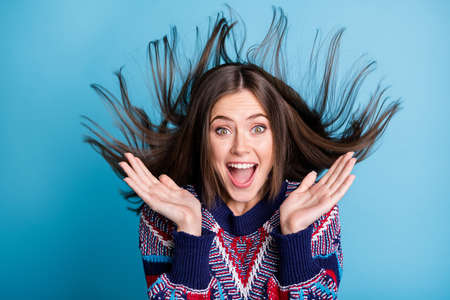 Photo portrait girl laughing surprised amazed with hair throwing in air isolated vivid blue color...