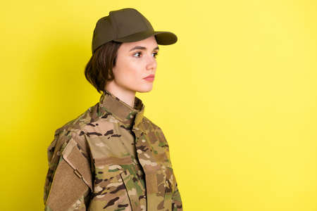 Profile portrait of charming focused girl look attentively empty space wear hat isolated on yellow...