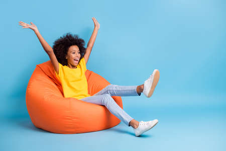 Full size photo of afro american volume hair little girl raise hands amazed sale isolated on blue color backgroundの写真素材