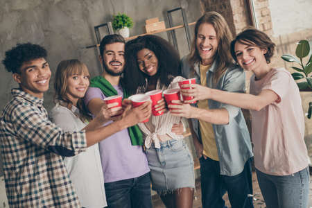 Photo portrait of students overjoyed happy drinking beer telling toast cheers at partyの写真素材