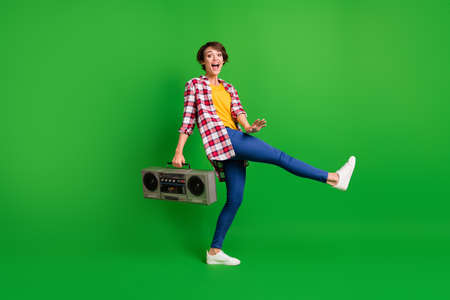 Full size profile photo of pretty funky lady dancing hold boombox wear jeans shirt sneakers isolated...