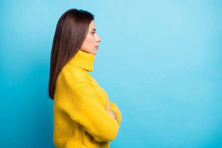 Profile side view portrait of attractive content calm girl folded arms copy space isolated over vibrant blue color backgroundの写真素材