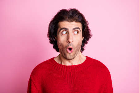 Portrait of young handsome shocked speechless surprised amazed man look copyspace isolated on pink color backgroundの写真素材