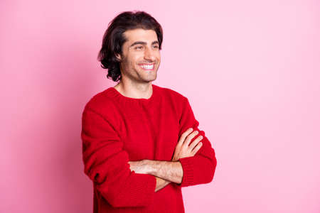 Portrait of young handsome happy smiling cheerful good mood man with crossed hands look copyspace isolated on pink color backgroundの写真素材
