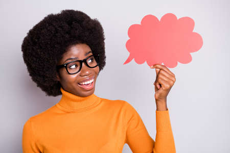 Photo of young black woman happy positive smile hold paper cloud speech talk dialog isolated over...