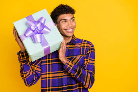 Photo portrait of curious guy try to guess what in the present gift box party looking empty space...