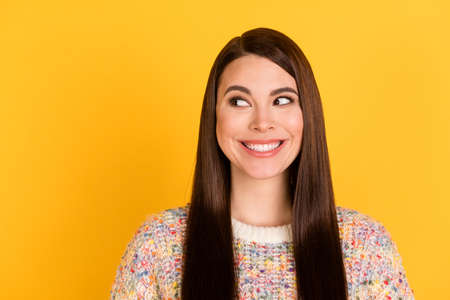 Photo of dreamy attractive pretty lady look empty space wear colorful sweater isolated on bright yellow color backgroundの写真素材