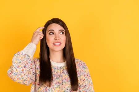 Photo of minded doubtful young woman look empty space scratch finger head isolated on shine yellow...