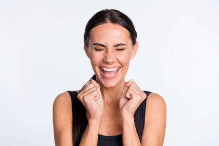 Photo of happy cheerful joyful young woman winner celebrate good mood isolated on grey color backgroundの写真素材