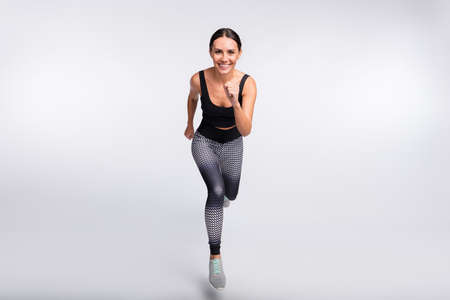Full length photo of brunette ponytail haired young lady smile good mood jump up run isolated on...