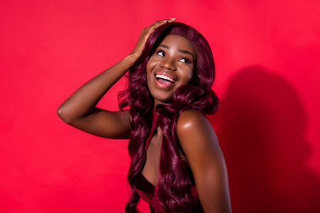 Photo of attractive nice afro american young woman look empty space hold hand empty space isolated...