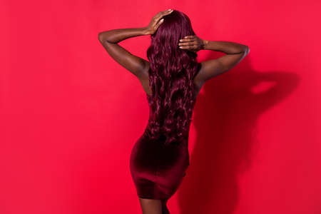 Rear back behind view of attractive gorgeous girl having fun posing event isolated over bright red...