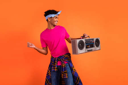 Photo portrait of young hipster dancing keeping boom box wearing headband casual clothes isolated on...