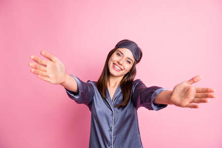 Photo portrait of pretty girl inviting to hug isolated on pastel pink colored backgroundの写真素材