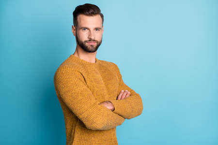 Photo of young handsome happy positive smiling man with folded hands look camera isolated on blue color backgroundの写真素材