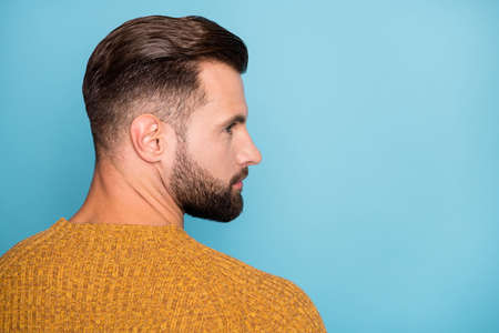 Rear back behind profile side view portrait of nice groomed guy wearing modern coiffure copy space isolated over bright blue color backgroundの写真素材