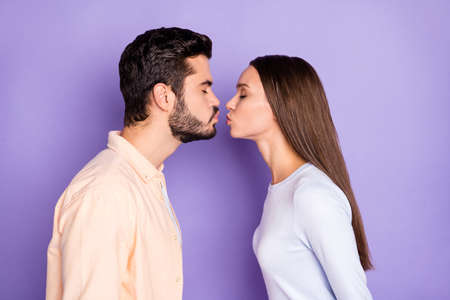 Profile side photo of young couple air kiss plump lips romantic date isolated on purple color...