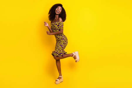 Full length body size view of pretty slender cheerful girl dancing having fun relax isolated over bright yellow color backgroundの写真素材