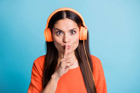 Photo of charming tricky lady finger covering lips do not tell isolated on pastel blue color backgroundの写真素材