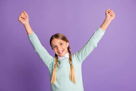 Photo portrait of cheerful positive girl celebrating isolated on vivid purple colored background