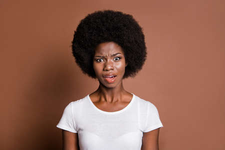 Photo of impressed unsatisfied dark skin person open mouth staring isolated on brown color backgroundの写真素材