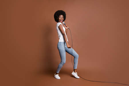 Full length body size photo of girl curious singing in microphone karaoke club entertaining isolated...