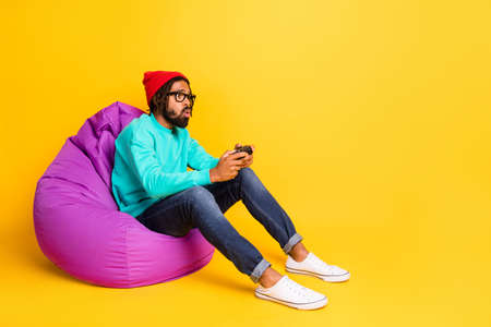 Full size profile photo of brunette optimistic guy  wear cap spectacles pullover jeans isolated on...