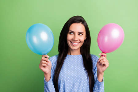 Photo of cute optimistic brown hair lady look balloons wear blue dress isolated on green color...