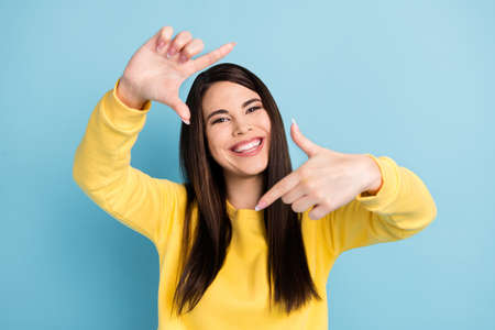 Portrait of nice optimistic brunette long hairdo lady show shot wear yellow shirt isolated on bright...