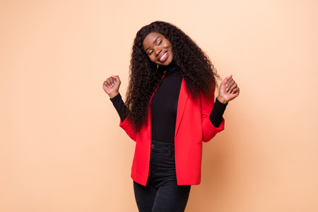 Photo of cheerful happy afro american young lady smile look empty space dream isolated on beige color backgroundの写真素材