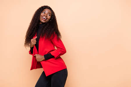 Photo of attractive beautiful dark skin girl look empty space wear glamour outfit isolated on beige color backgroundの写真素材