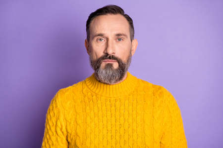 Photo of mature handsome man beard serious confident wear casual sweater isolated over violet color backgroundの写真素材