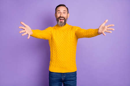 Photo of impressed satisfied person raise hands camera you open mouth unbelievable isolated on violet color backgroundの写真素材