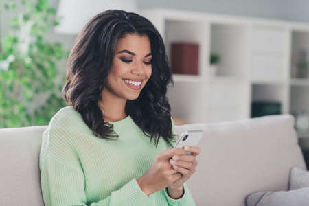 Profile side photo of young attractive woman happy positive smile look read browse cellphone sit...